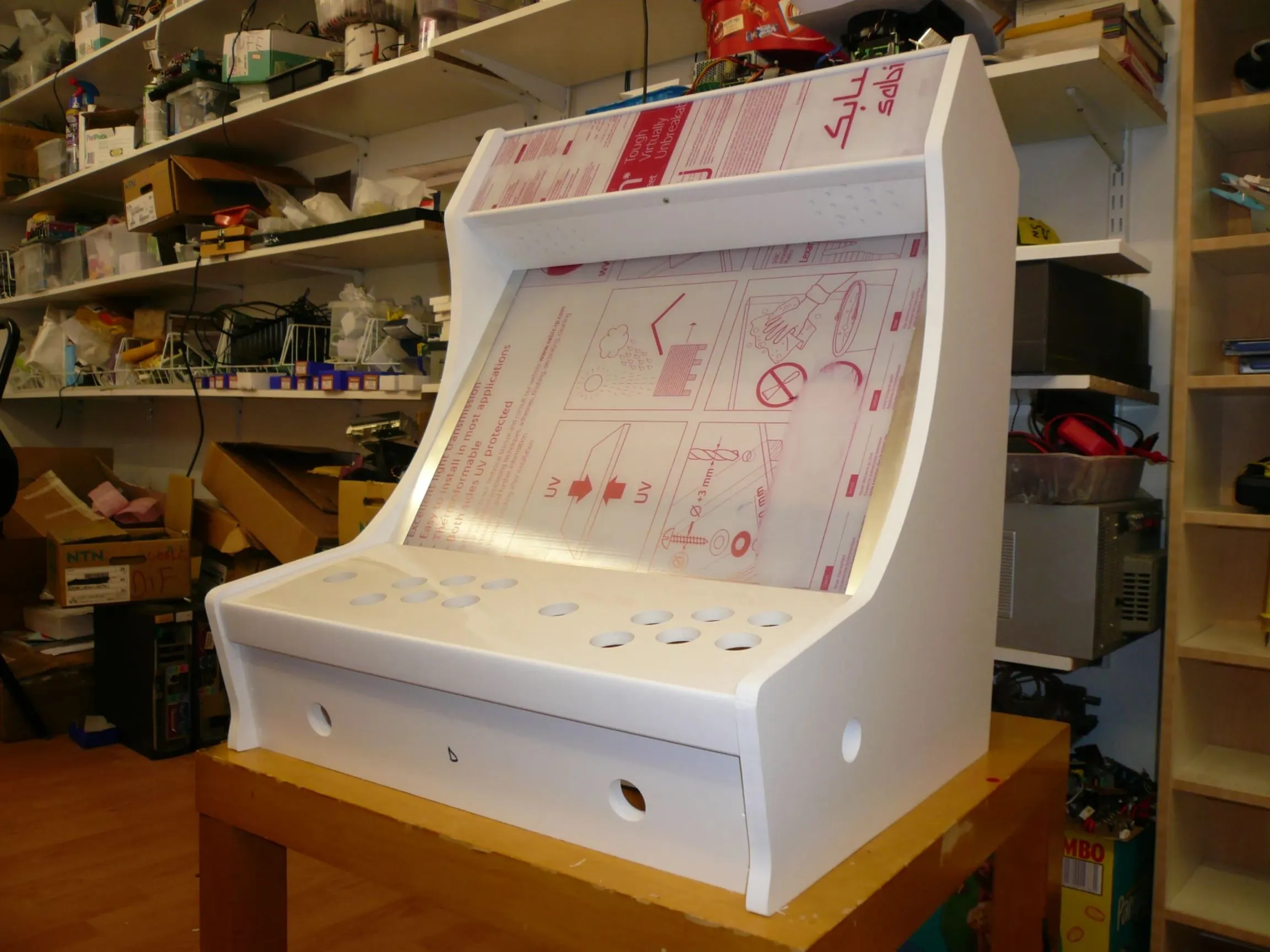 Handcrafted DIY bartop arcade cabinet being assembled in a retro gaming workshop