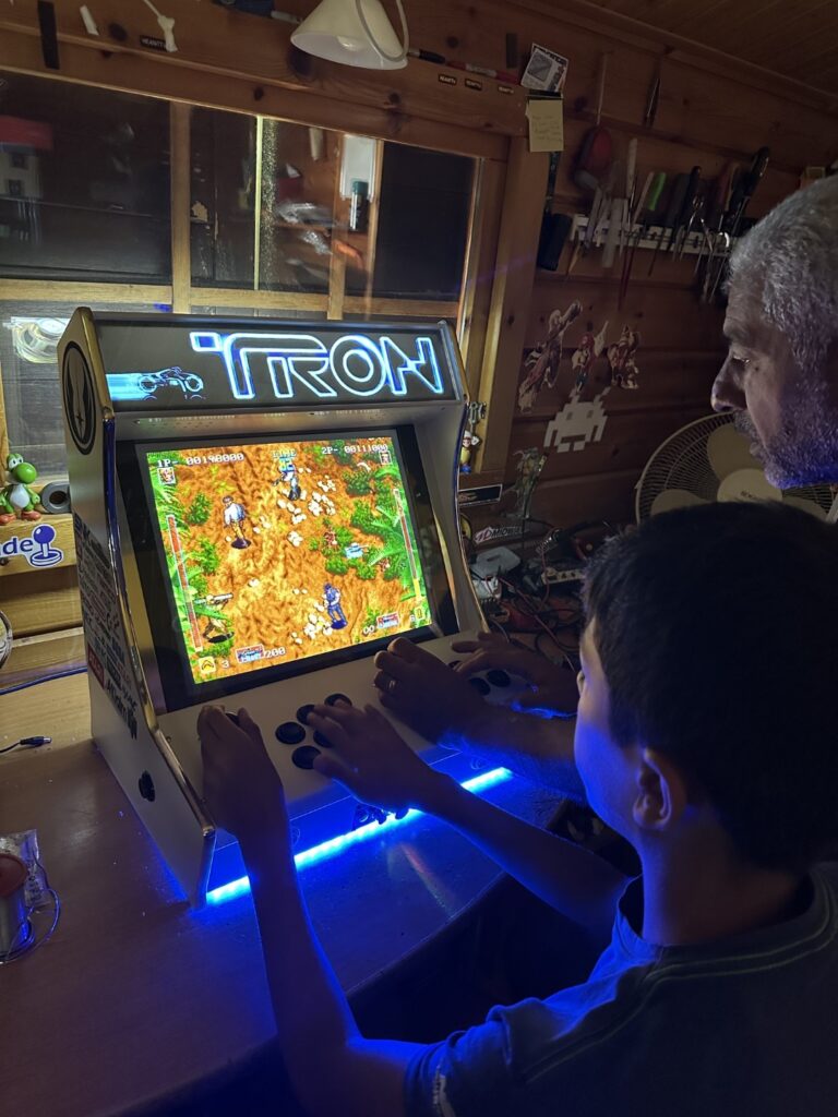 Father and son enjoying a handcrafted custom arcade machine built for authentic home arcade gaming.