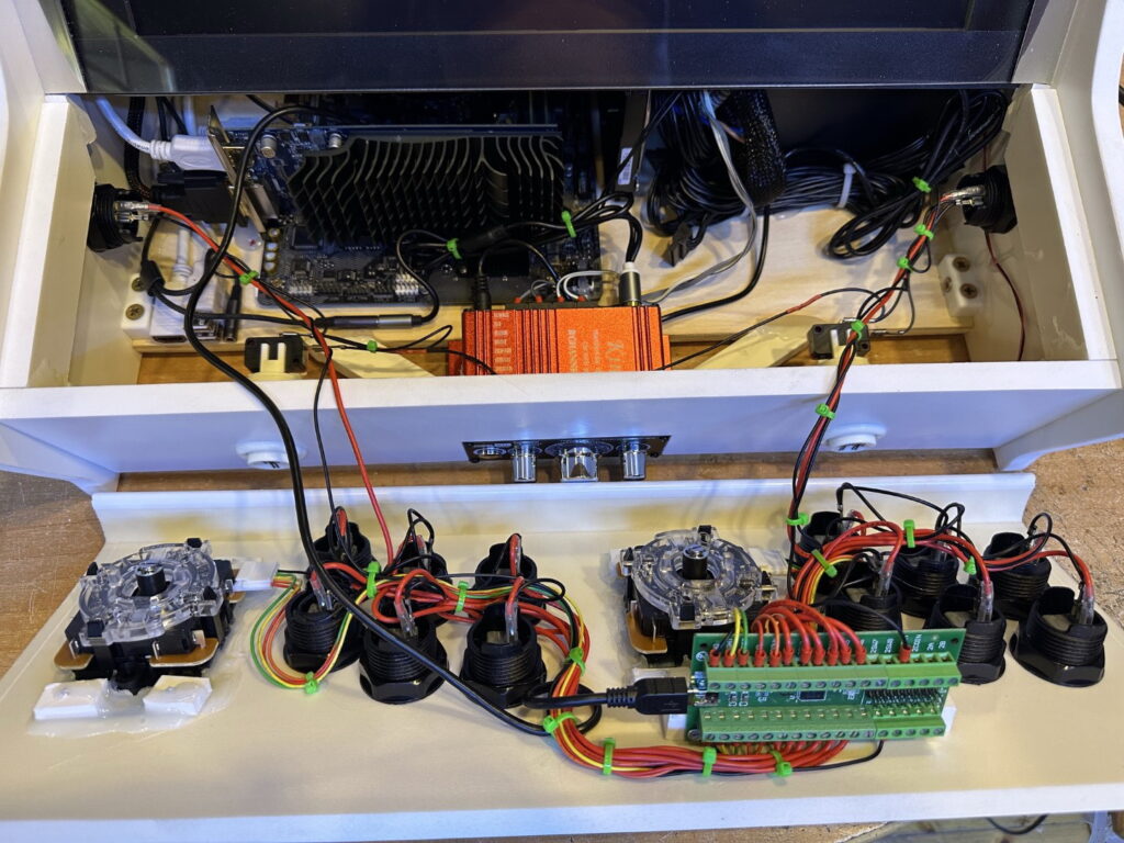 Hand-built custom arcade machine showing authentic arcade controls, Ultimarc I-PAC 2 encoder and premium internal components.